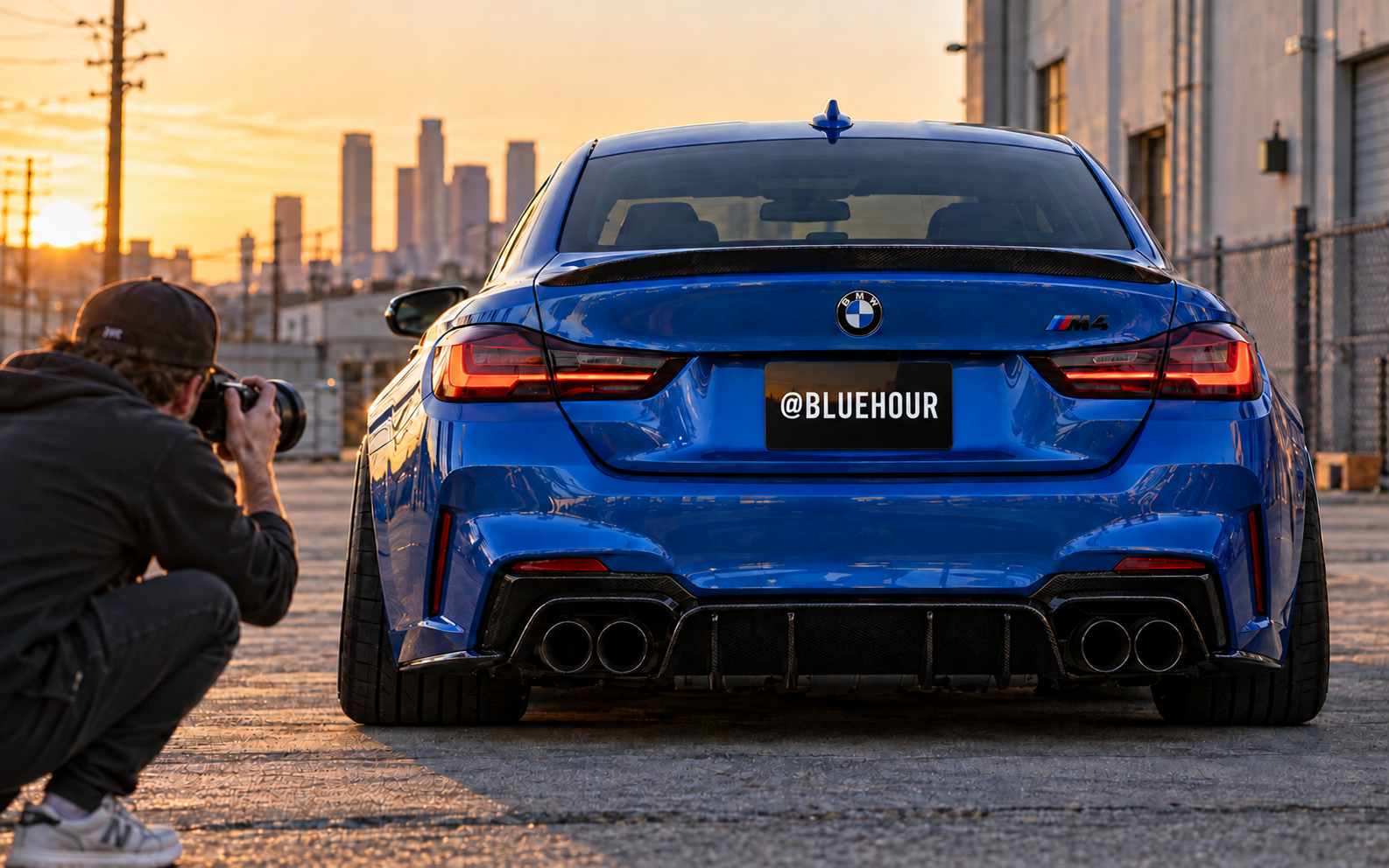 Photographer shooting a blue BMW M4 with an @BLUEHOUR plate cover at sunset