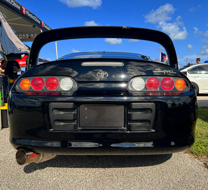 Black Toyota Supra with a real carbon fiber plate cover