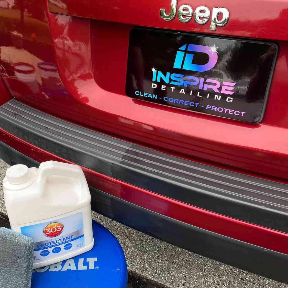 Custom detailing shop plate cover on the back of a red Jeep